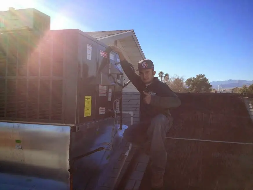 HVAC technician performing Air Duct Repair on a rooftop unit in Waihee-Waiehu